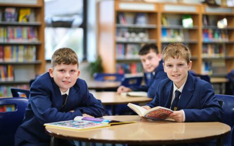 Two students reading a book